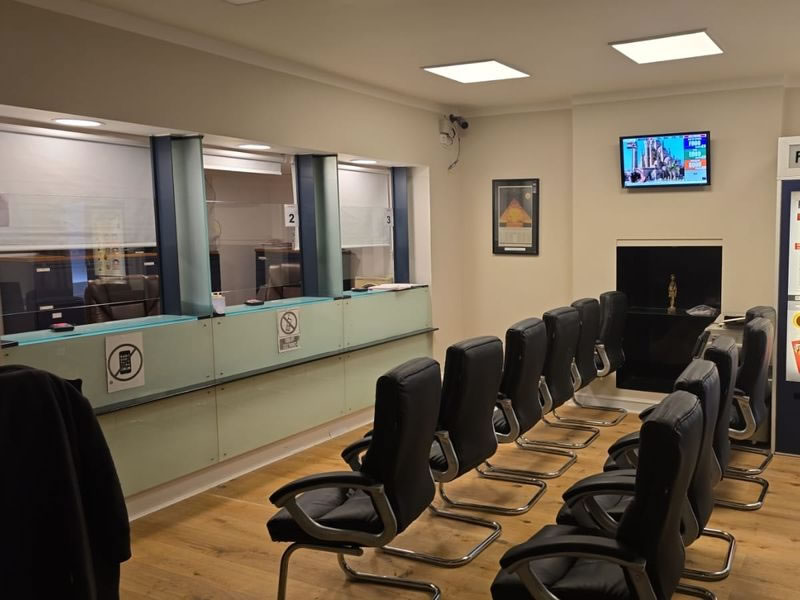 Waiting room with service counters and queue display at the Egyptian Consulate in London